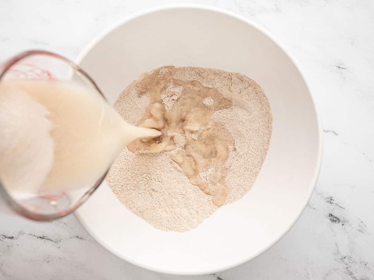 Yeast water being added to the flour mixture.