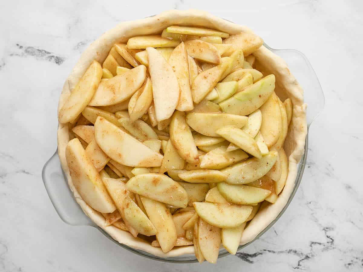 Overhead shot of sliced apples in pie shell.