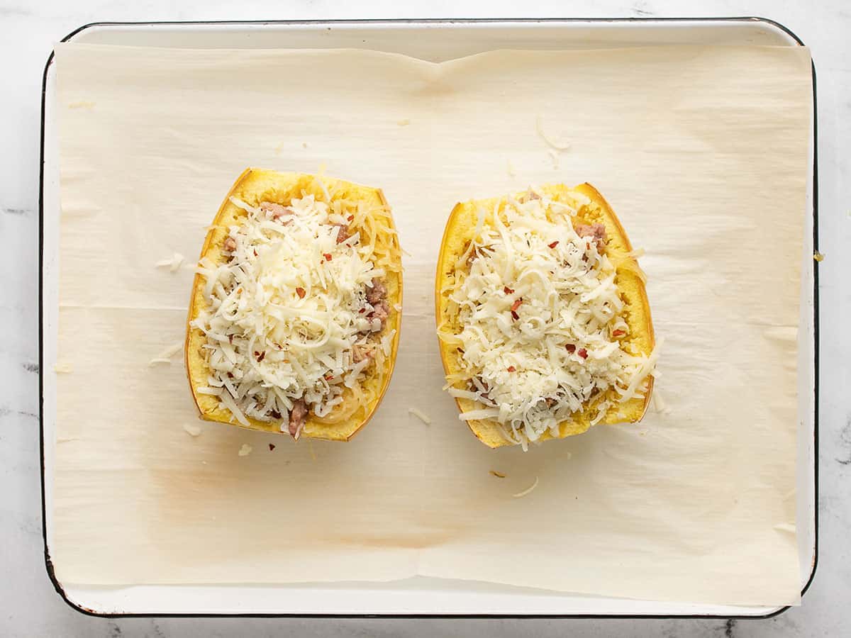 Overhead shot of stuffed spaghetti squash on a sheet pan.