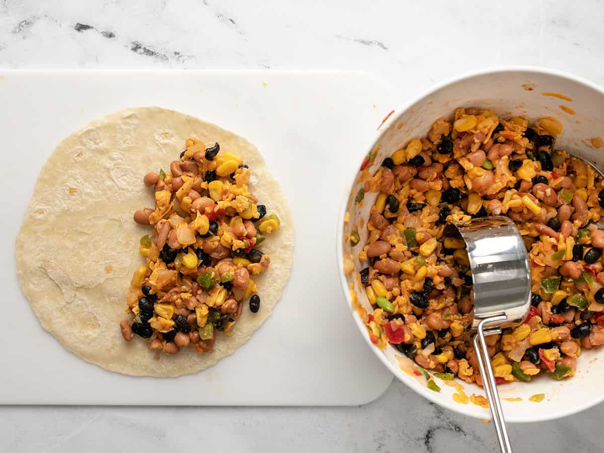 Tortillas being filled with quesadilla mix. 