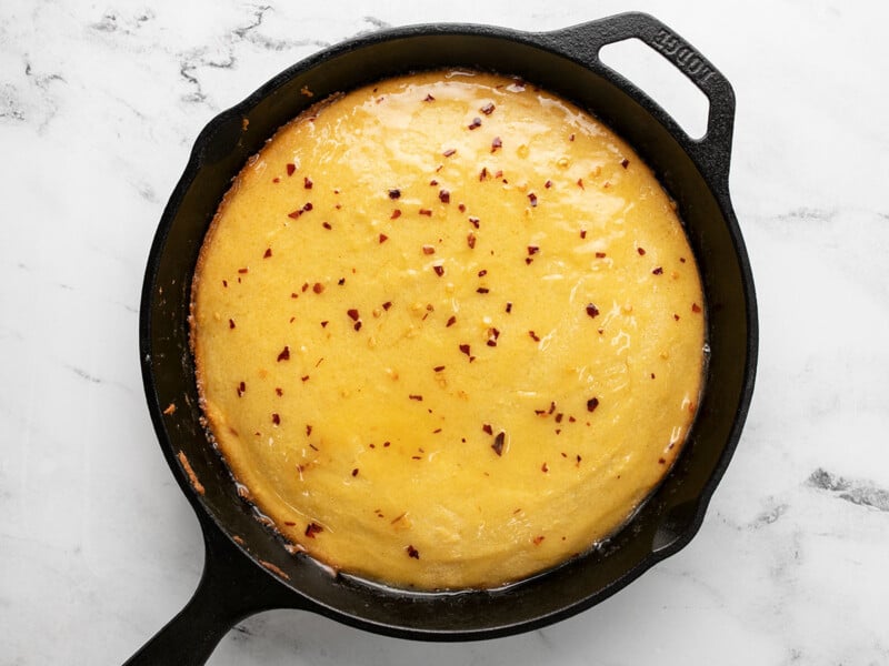 Overhead shot of cornbread in a cast iron skillet.