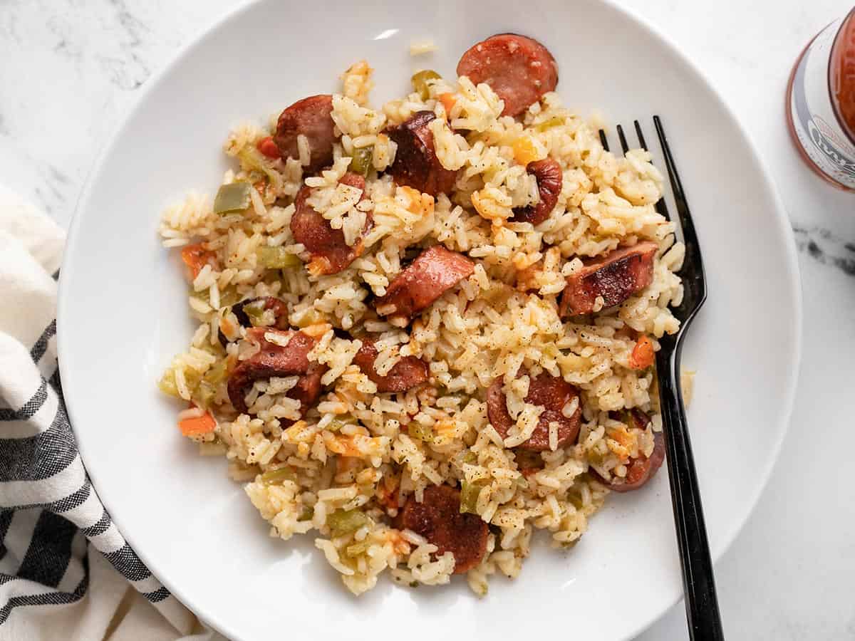 Overhead view of a plate full of sausage and rice.