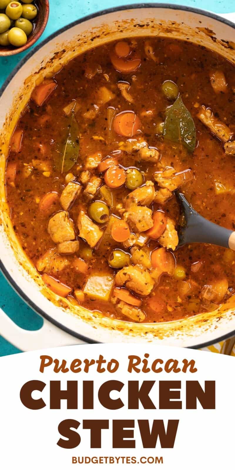 Overhead shot of Guisado de Pollo in a white Dutch oven with a spoon in it.