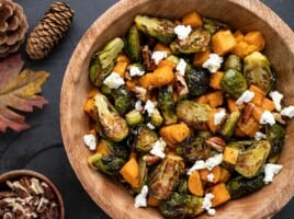 Close up view of roasted Brussels Sprouts Salad in a wooden bowl.