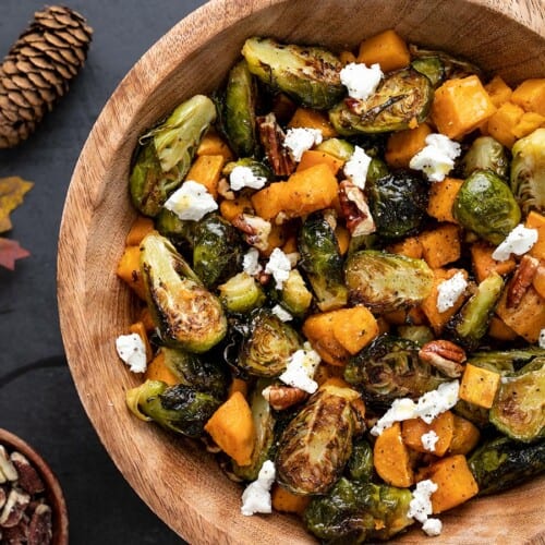 Close up view of roasted Brussels Sprouts Salad in a wooden bowl.