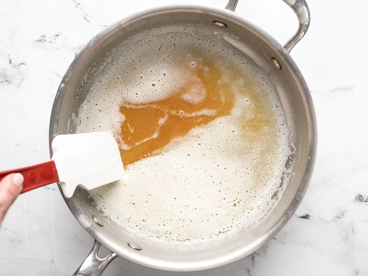 Overhead shot of butter browning in a pot.