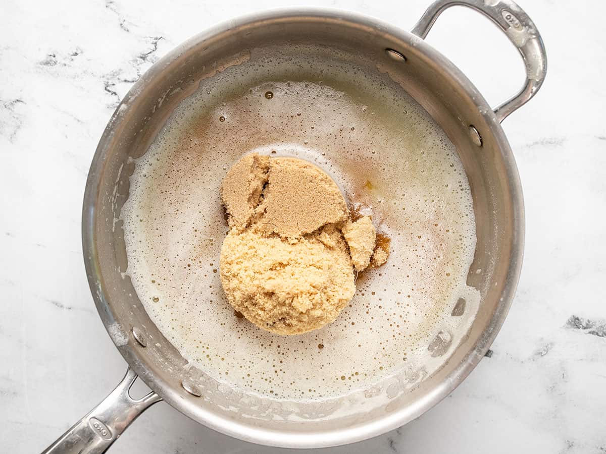 Overhead shot of brown sugar being cooked in a pot with butter.