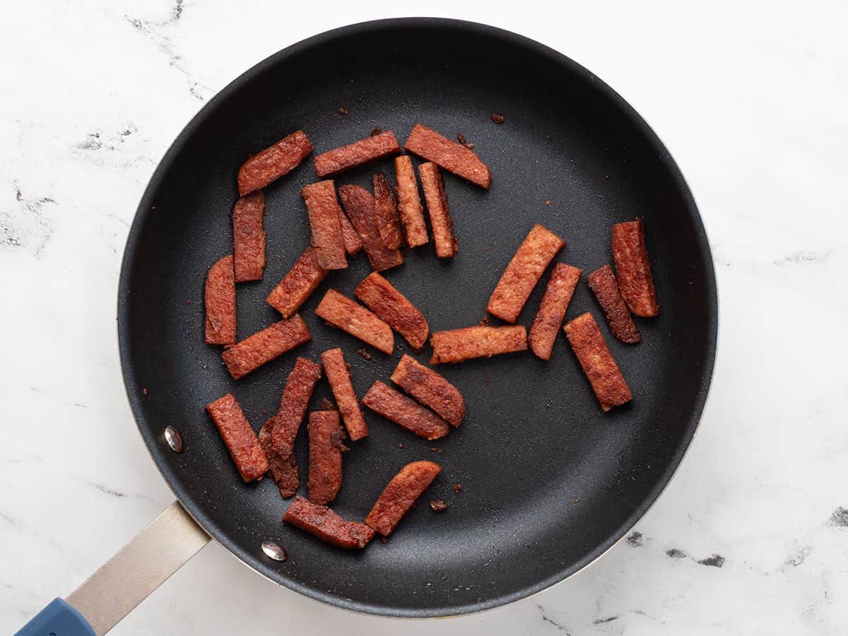 Fried luncheon meat in a skillet.