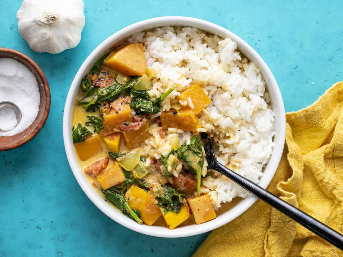 Overhead view of a bowl of butternut squash curry with rice.