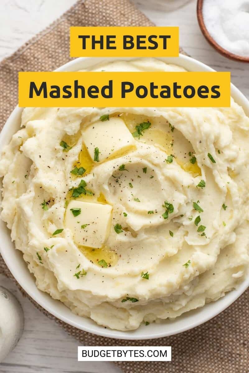 Overhead view of a bowl of mashed potatoes with melting butter.