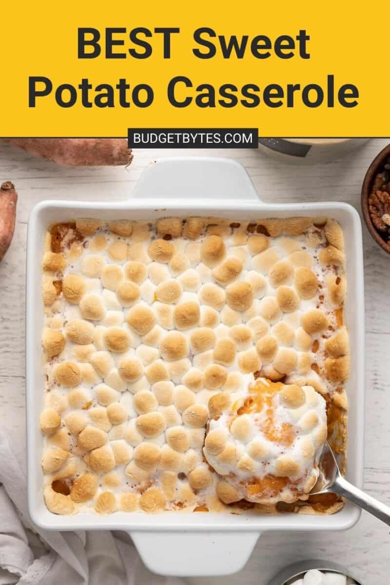 Overhead shot of sweet potato casserole in a white casserole dish with a silver serving spoon scooping out a bit of it.