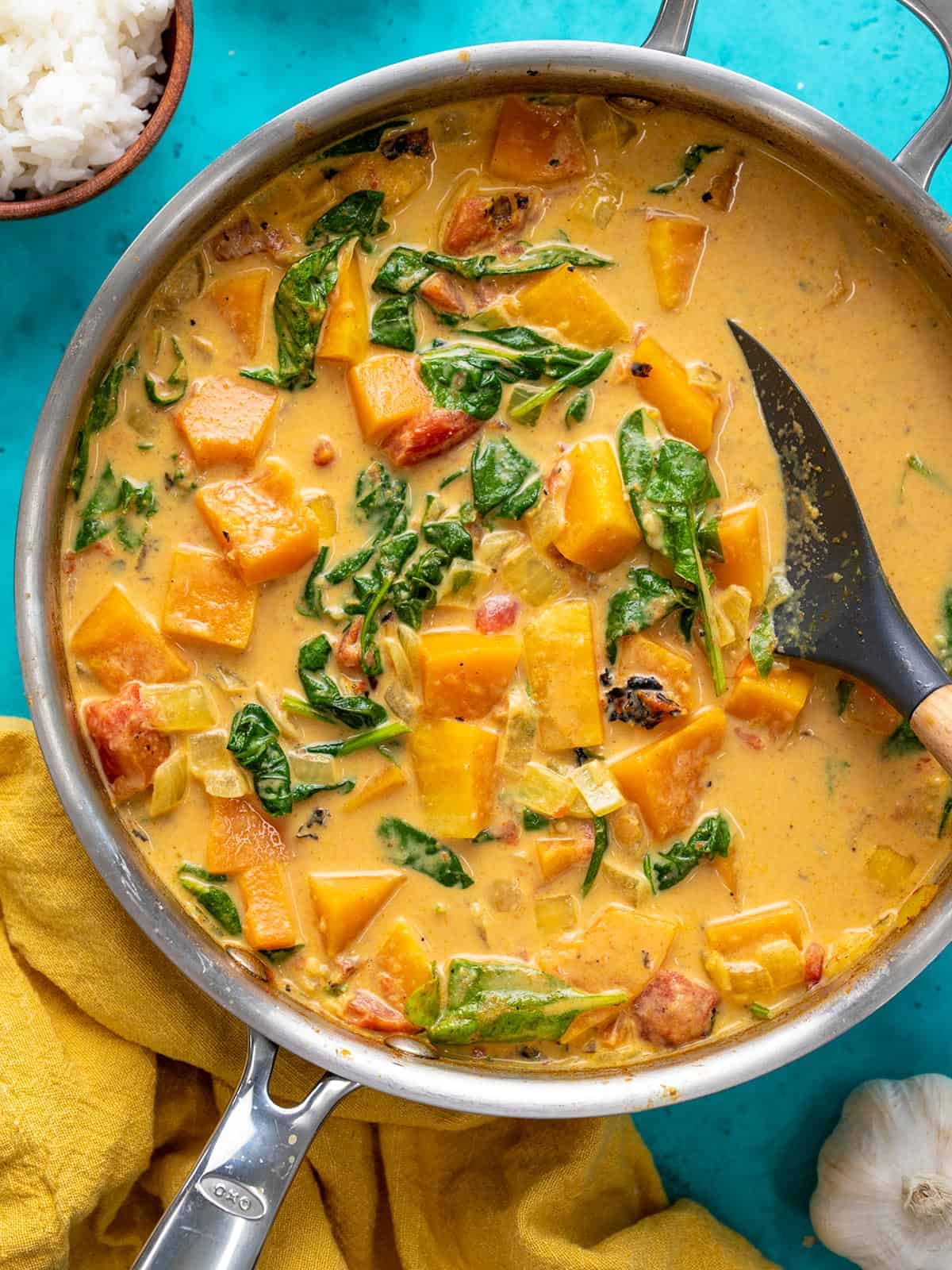 Overhead view of a skillet full of butternut squash curry.