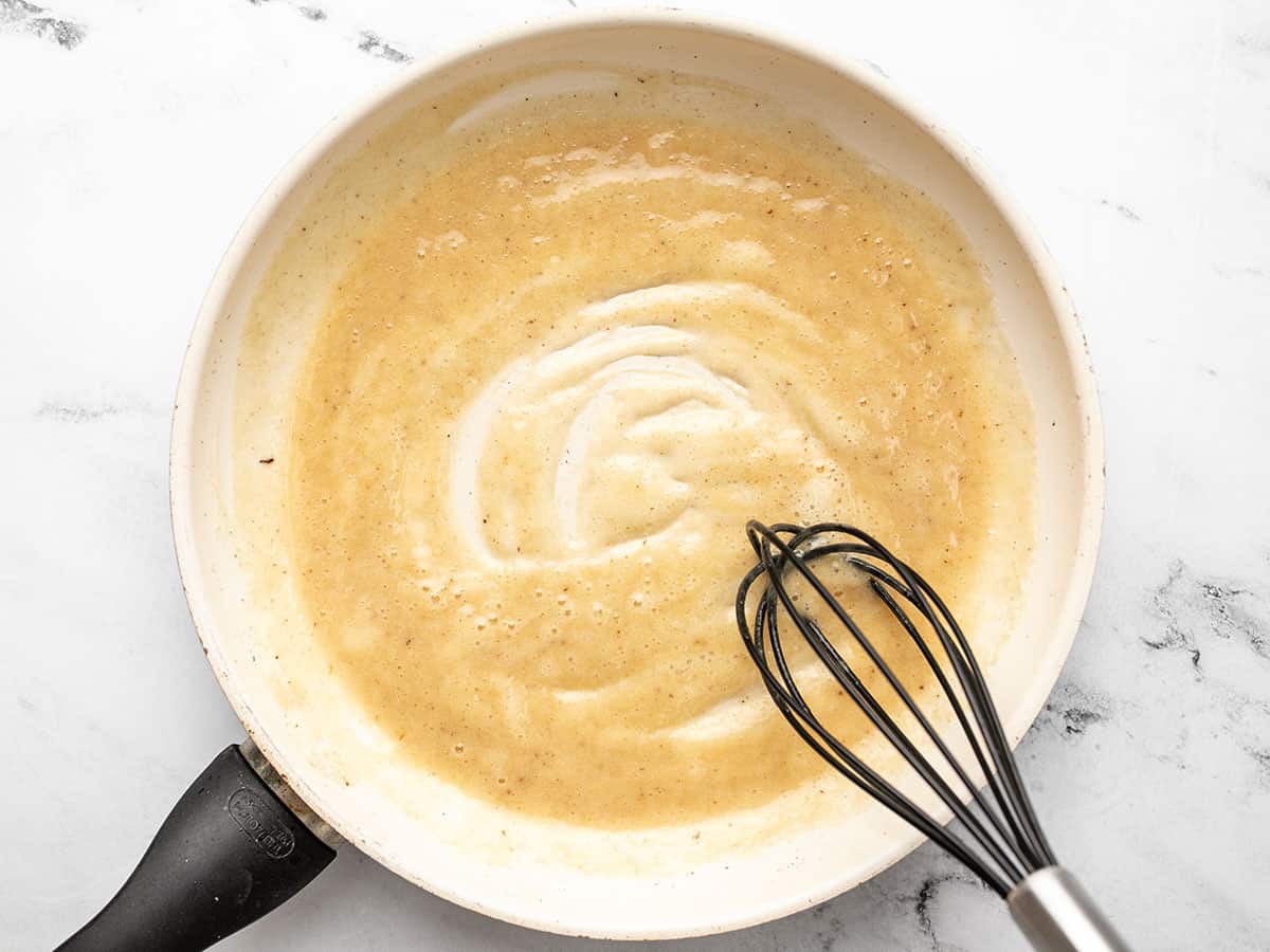 Roux being whisked in the skillet.