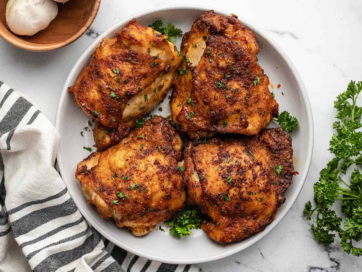 Overhead view of air fryer chicken thighs on the plate. 