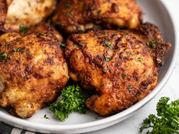 close up side view of air fryer chicken thighs on the plate.