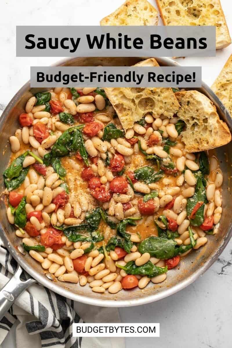 Overhead view of a skillet full of saucy white beans.