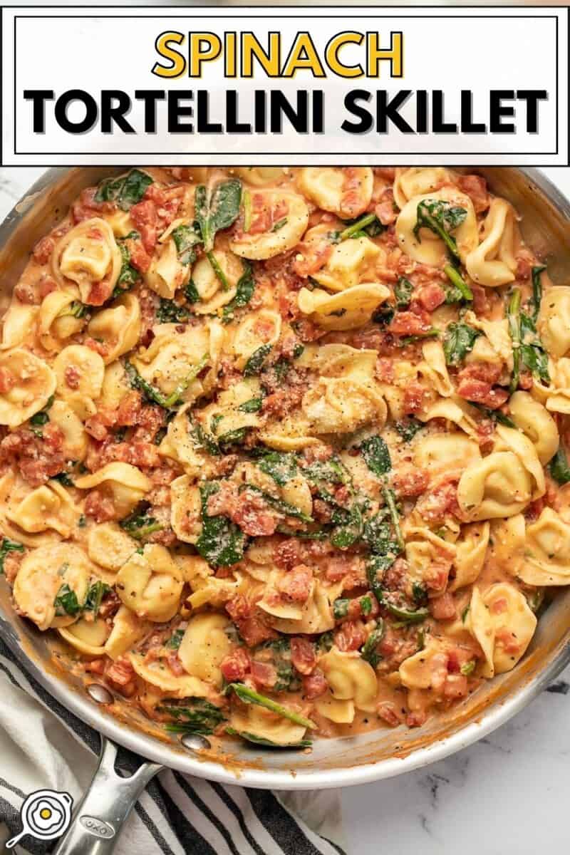 Overhead view of a skillet full of spinach tortellini.