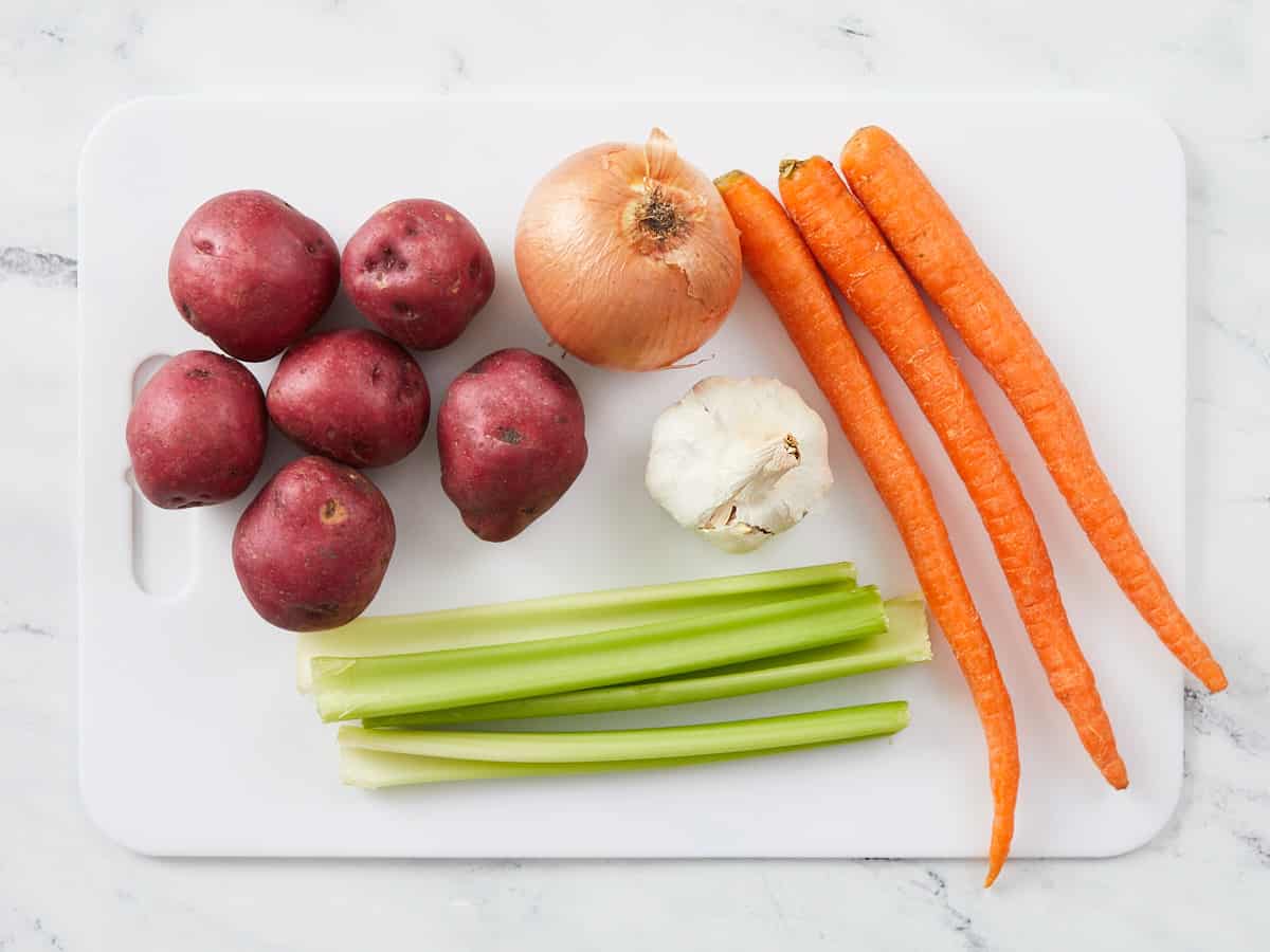 Vegetables for beef stew on a cutting board. 