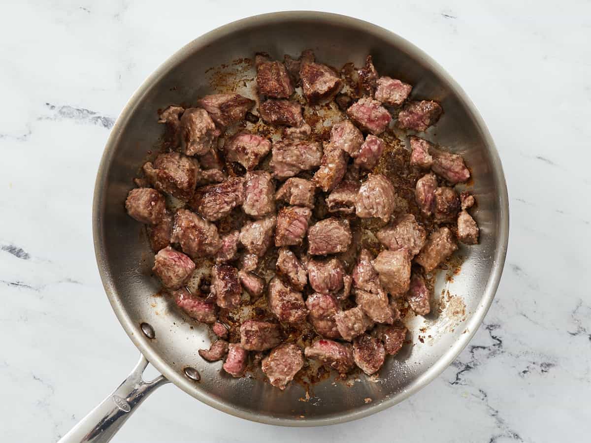 Browned beef in a skillet.