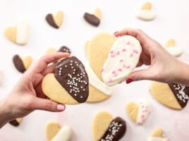 Overhead shot of Valentine's Day Cookies being held by two hands.