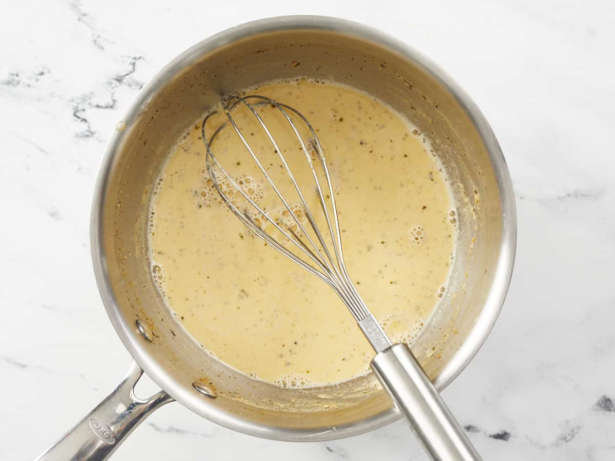 Heated broth, cream, and seasonings in the pot.