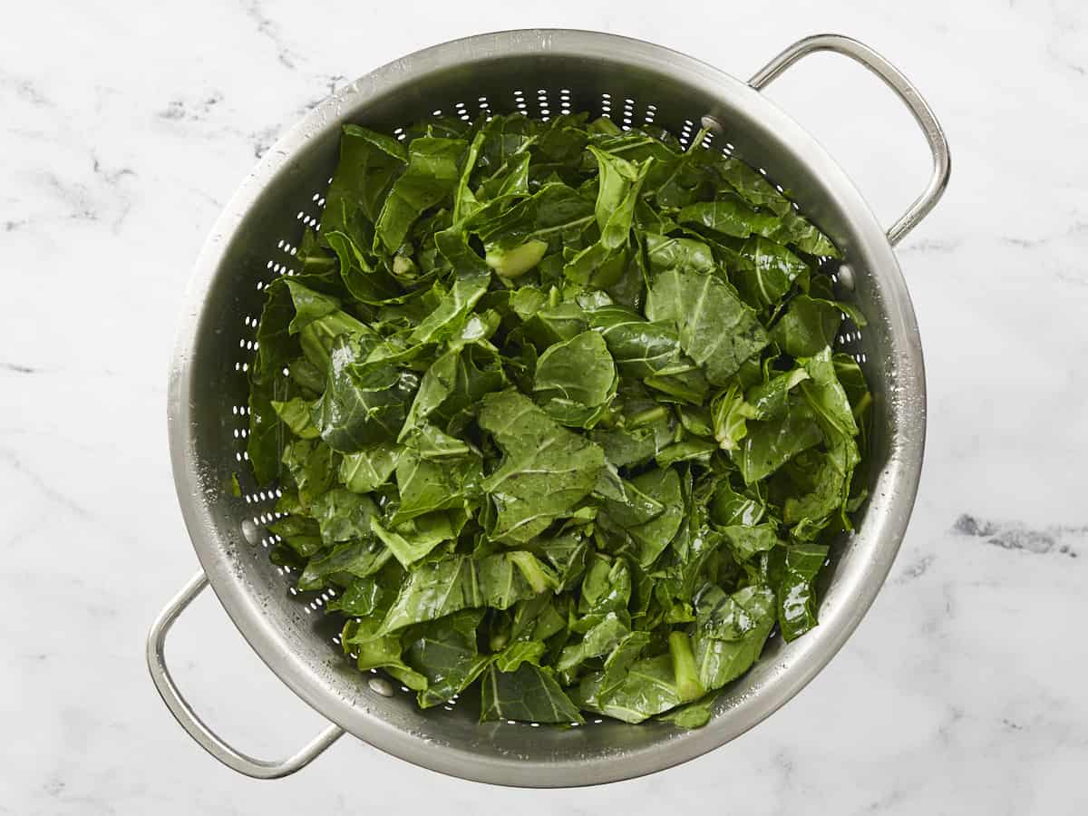 Washed collard greens in a colander.