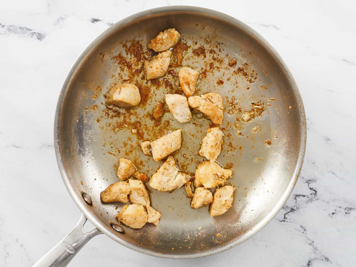 Cooked chicken in a skillet.