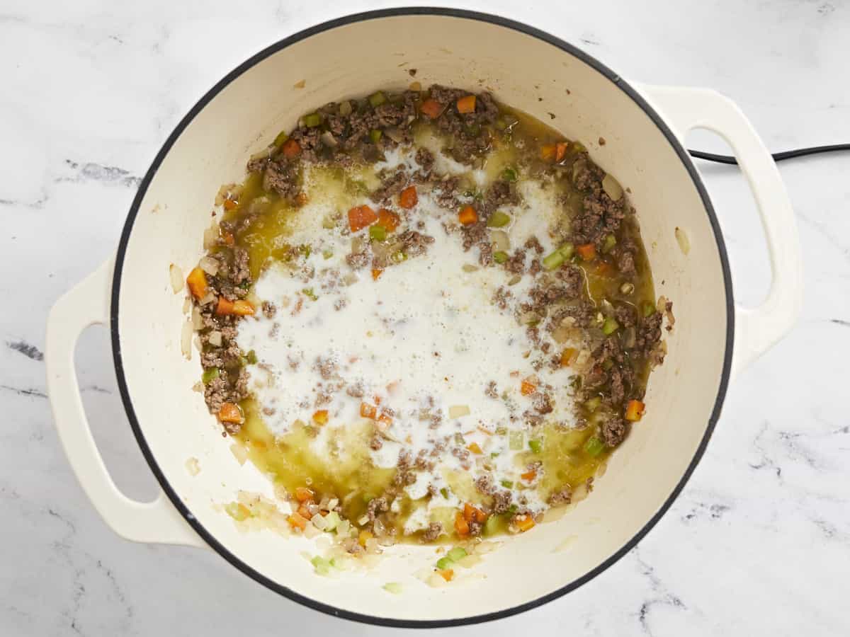 Overhead shot of sauteed beef and veg with milk in it.