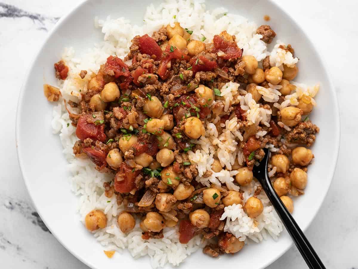 Overhead shot of Beef and Tomato Rice Bowl with fork in it.