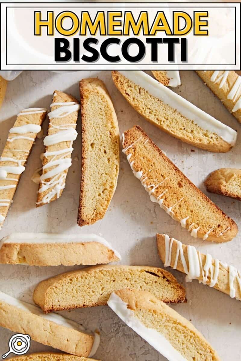 Homemade biscotti scattered on a surface near a cup of coffee.