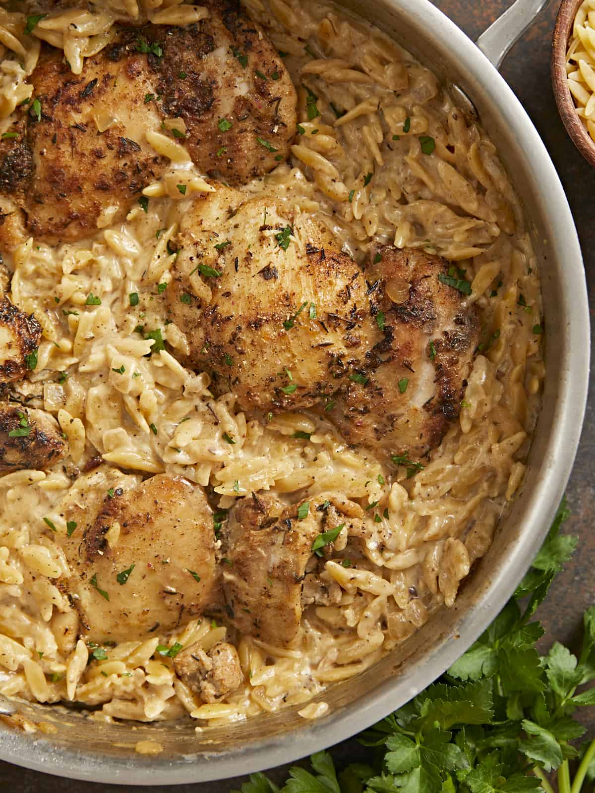 Overhead shot of Creamy Chicken and Orzo in a silver skillet.