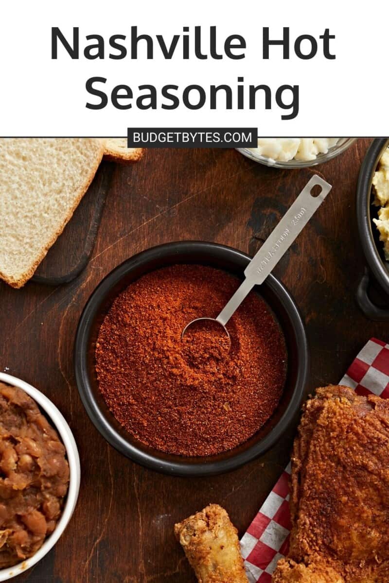 Overhead shot of Nashville Hot Seasoning in a black bowl with a silver measuring spoon in it.