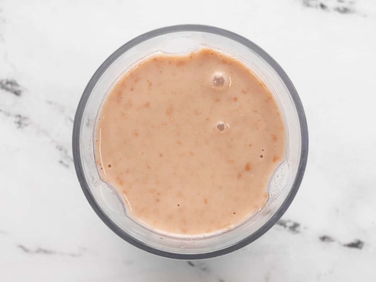 Puréed pinto beans in a blender.