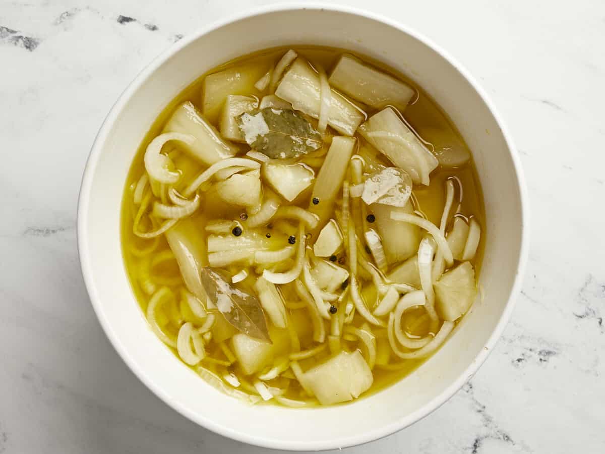 Overhead shot of Yuca En Escabeche in a white bowl.