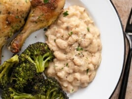 Overhead view of Parmesan Beans on a plate with chicken and broccoli.