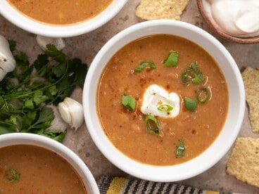 Close up overhead view of three bowls of pinto bean soup.