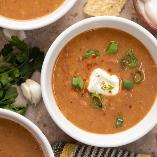 Close up overhead view of three bowls of pinto bean soup.