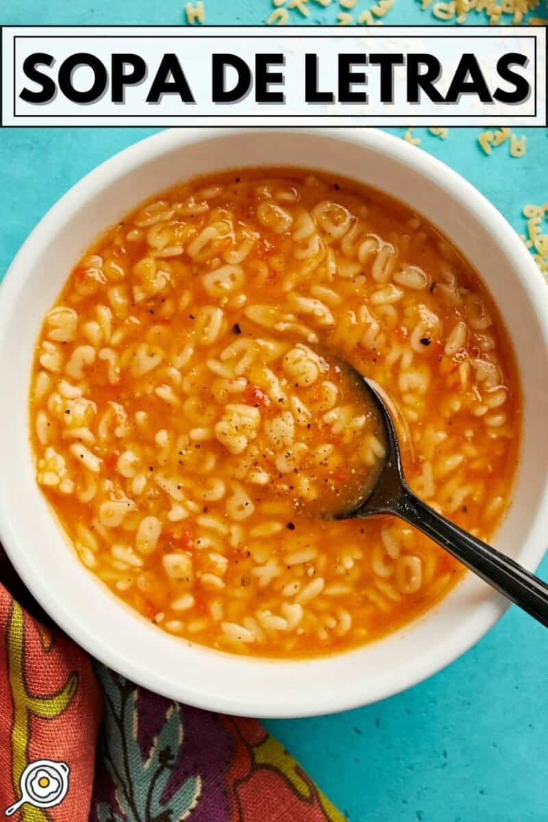 Overhead shot of Sopa De Letras in a white bowl with a spoon in it.