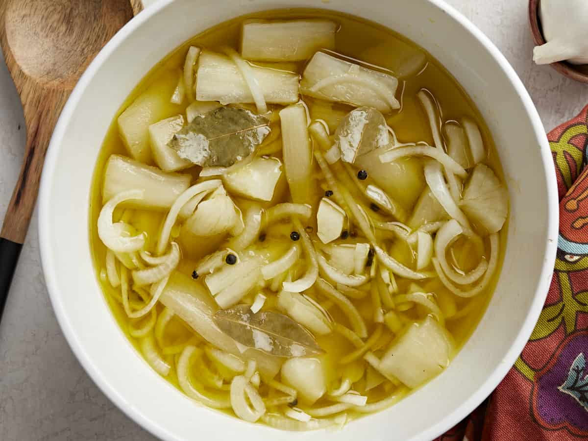 Overhead shot of Yuca En Escabeche in a white bowl.