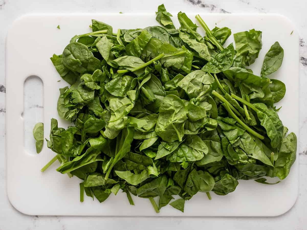 Chopped spinach on a cutting board.