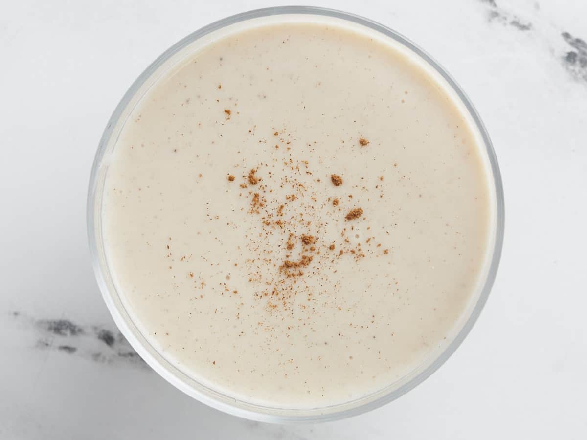 Overhead shot of finished Maizena in a white bowl with cinnamon sprinkled on top.