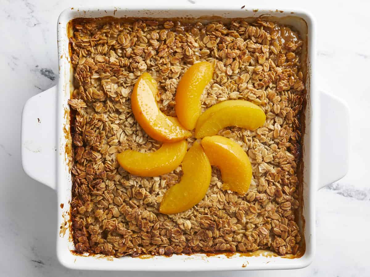 Overhead shot of Peach Baked Oatmeal in a white baking dish.