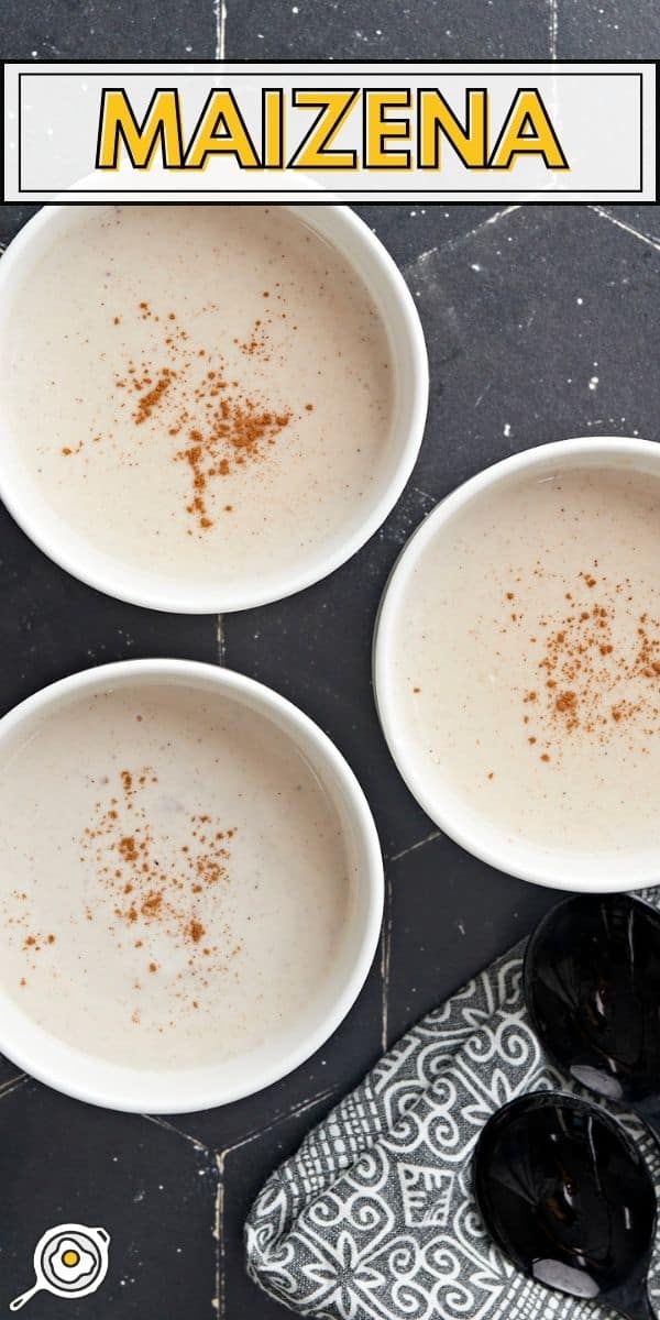 Overhead shot of three white bowls of Maizena with cinnamon sprinkled on top.