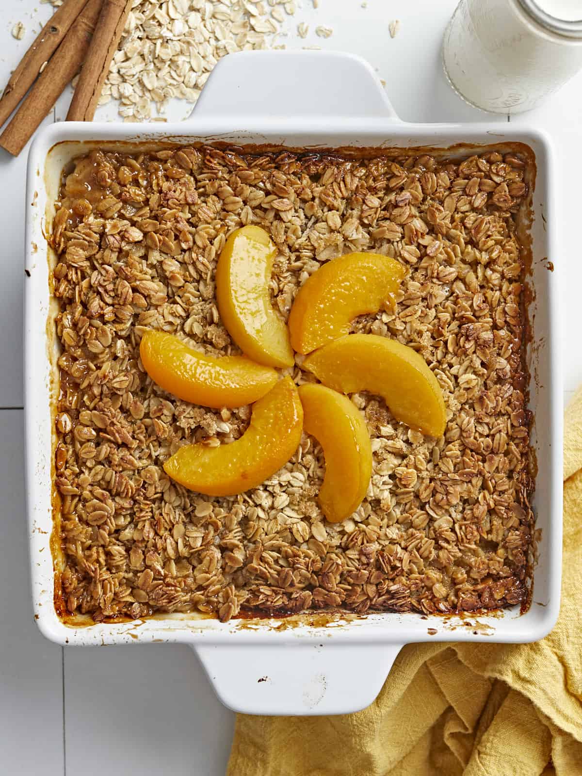 Overhead shot of Peach Baked Oatmeal in a white baking dish.