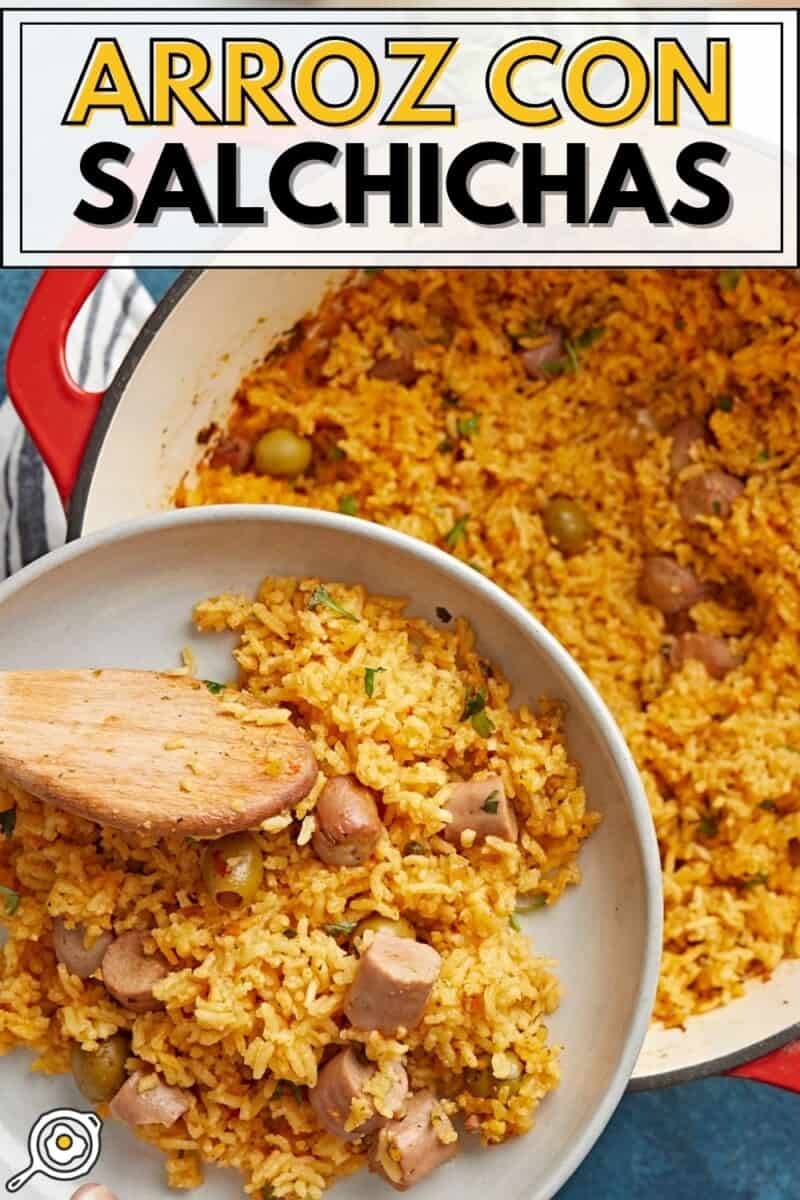 Overhead shot of wooden spoon serving rice out of a red Dutch oven onto a white plate.