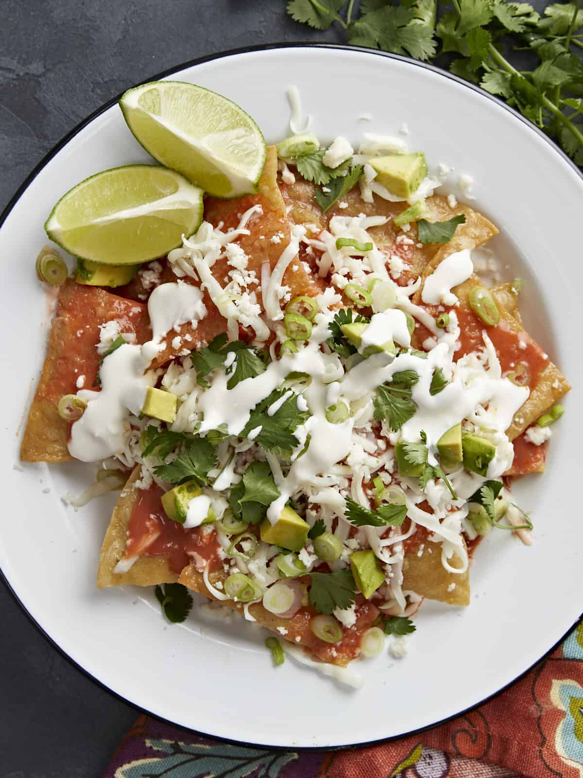 Overhead shot of chilaquiles served on a white plate.