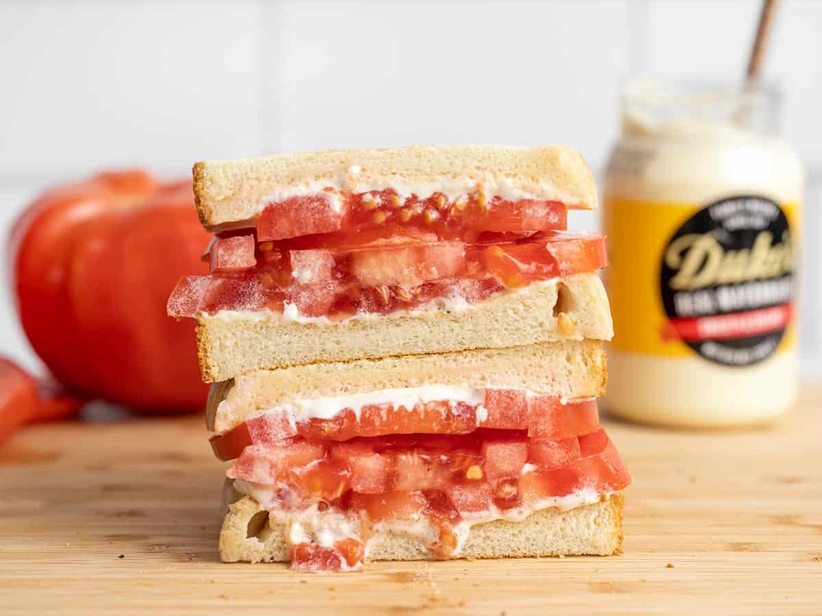 Side view of a sliced and stacked tomato sandwich.