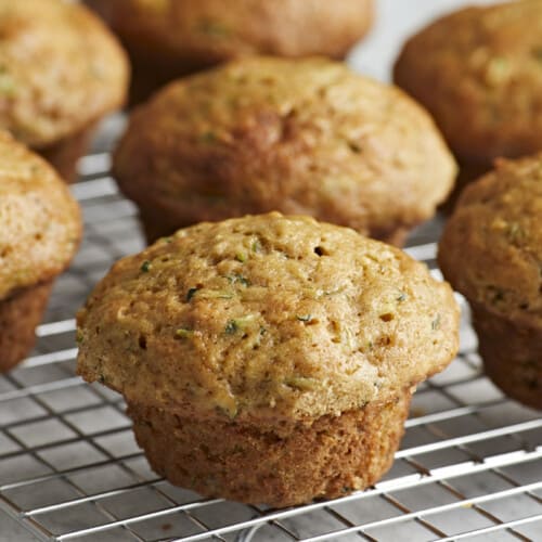 Side view of Zucchini muffins on a wire rack.