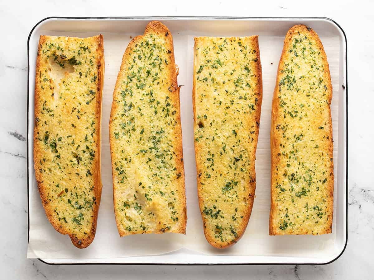 Baked garlic bread on a baking sheet.