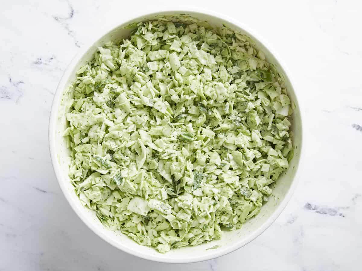 Overhead shot of Green Goddess Salad in a white bowl.